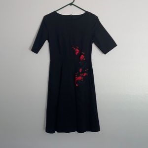 Vintage 50s style black dress with floral details.